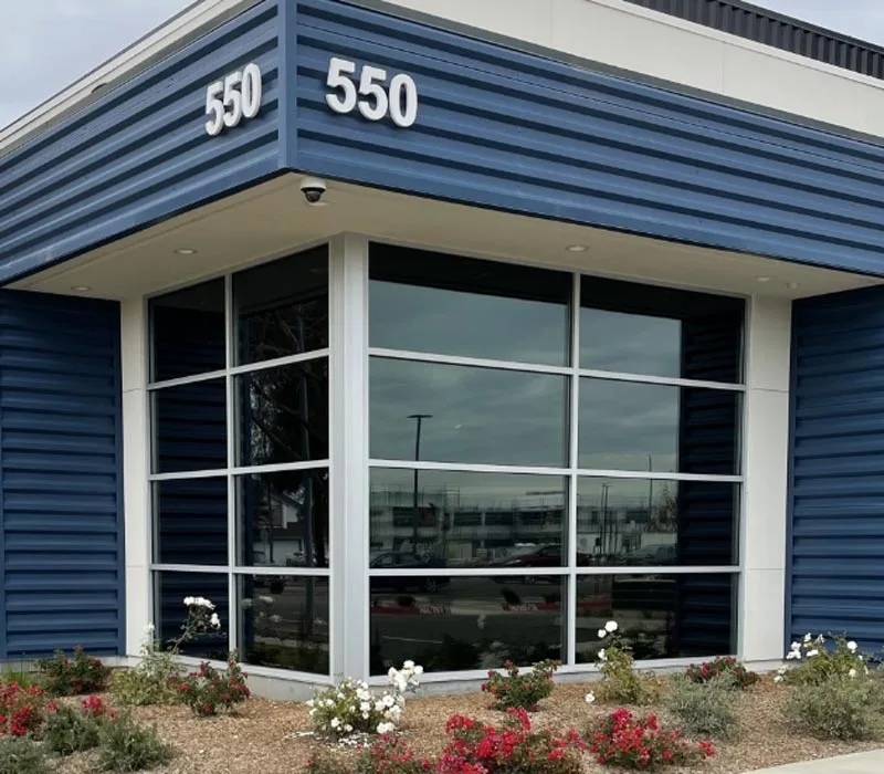 Clean exterior view of professional solar control window film on a Dallas office storefront building